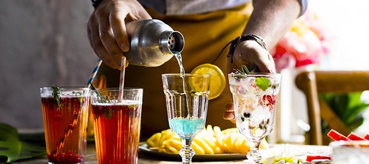 Close up of bartender pouring a drink into a glass